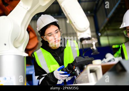 Industrial engineers checking and controlling machine at factory Stock Photo