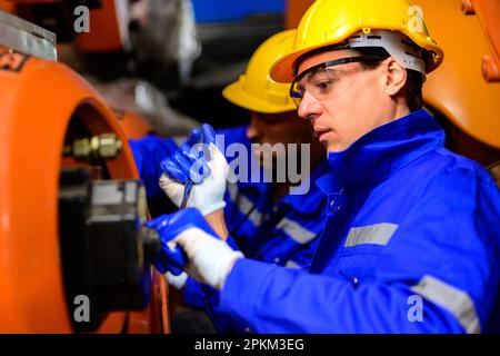 Professional engineers technicians working at industrial factory Stock Photo