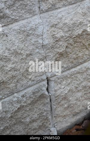 Cracks in a concrete block foundation, in need of repair Stock Photo