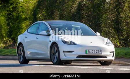 2022 TESLA MODEL 3 STANDARD RANGE + car travelling on an English country road Stock Photo