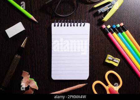 Top view of notepad with stationery products at table Stock Photo - Alamy