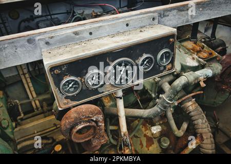 Dial gauge dashboard of a diesel engine in a engine room of a boat showing RPM and other measurements Stock Photo