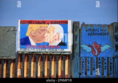 Tijuana, Baja California, Mexico. 7th Apr, 2023. Life in Playas de Tijuana's beach border between the U.S. and Mexico with a new mural in protest of the deconstruction of Friendship Park showing Trump and U.S. President Biden kissing, painted by Mexican artists Cuauhtli and Salazar on Friday. This mural is a comparison of the original picture depicting Brezhnev, leader of the USSR and Honecker of East Germany in a socialist fraternal kiss, reproducing a photograph taken in 1979 during the 30th anniversary celebration of the foundation of the German Democratic Republic. (Credit Image: © Carlos Stock Photo