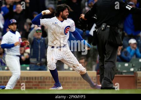 Chicago Cubs' Dansby Swanson slides safely into third base during