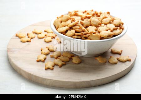 Delicious goldfish crackers in bowl on table Stock Photo