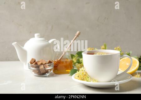 Cup of tea with linden blossom on light grey marble table Stock Photo