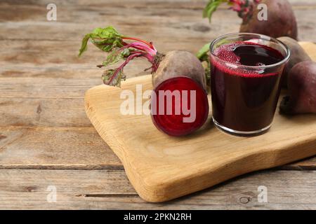 Freshly made beet juice on wooden table Stock Photo