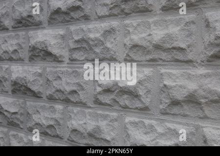 Textured, white cinder block wall. Showing the side of a building. Stock Photo