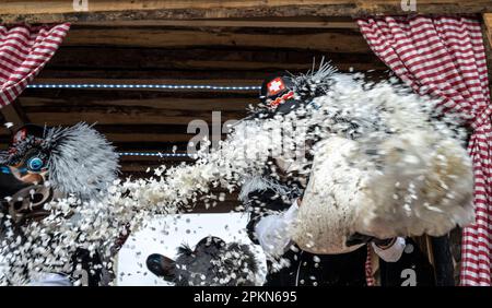 Waggis costume inside a parade float throwing confetti at the Basel Fasnacht carnival in Switzerland Stock Photo