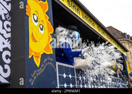 Waggis costume inside a parade float throwing confetti at the Basel Fasnacht carnival in Switzerland Stock Photo