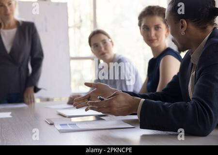 Hands of young Black business professional man talking to colleagues Stock Photo