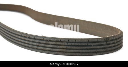 old used and worn out vehicle drive belt, isolated on white background, failed and cracked serpentine belt taken in selective focus, replaceable parts Stock Photo