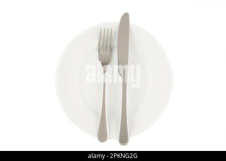 Dining etiquette - the meal is over or finished. Fork and knife signals with location of cutlery set. Photo isolated on white background. Set of foto Stock Photo