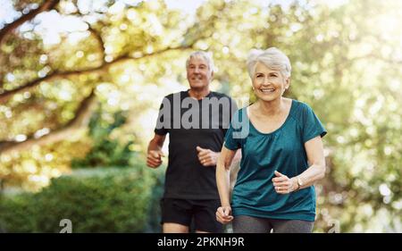 Improving their health and wellbeing together. a senior couple out for a run together. Stock Photo