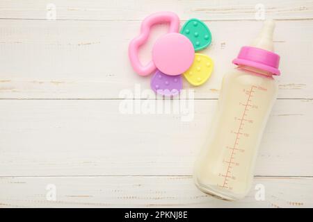 Baby milk with toys on white background. Top view Stock Photo