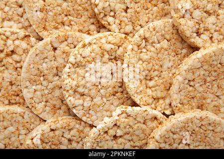 A stack of dietary round, airy, crisp buckwheat crispbread background. Top view Stock Photo
