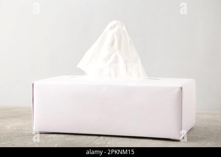 White tissue box on grey background. Top view Stock Photo