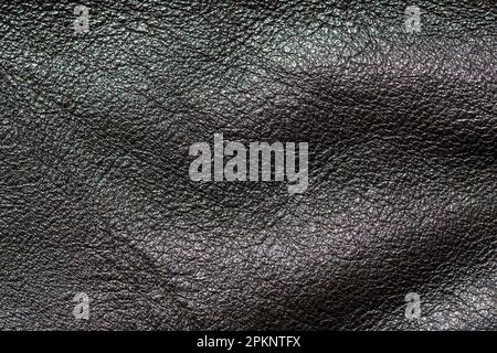 A close-up of a textured black leather pattern, creating an abstract and unique textile background. Stock Photo