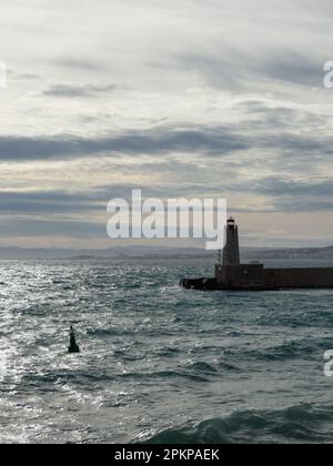 NICE, FRANCE- CIRCA MARCH, 2023: Nice port lighthouse with cloudy sky, travel content Stock Photo