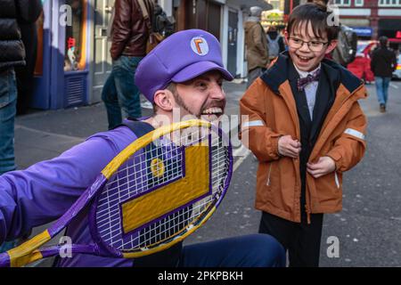 Waluigi from The Super Mario Bros. Movie meets a fan in London. Stock Photo