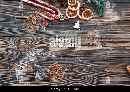 Candies and slices of oranges. Christmas background with holiday decoration Stock Photo
