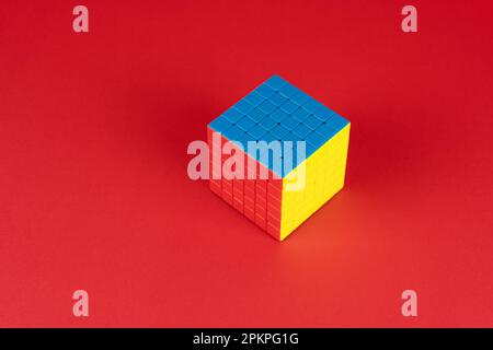 Colorful puzzle cube on red background Stock Photo