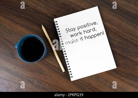 Coffee and note pad with text - Stay positive, work hard, make it happen Stock Photo