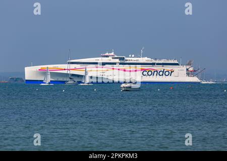 Sandbanks, Poole, Dorset UK. 9th April 2023. UK weather: warm and sunny at Sandbanks in Poole as Condor Ferries ferry Condor Liberation leaves Poole Harbour in the sunshine with sailing boats around. Today, Easter Sunday, is forecast to be the hottest day of the year so far with the forecast of rain tomorrow. Condor Liberation can carry up to 245 cars and 880 passengers between the UK, Jersey, Guernsey and Cherbourg. Credit: Carolyn Jenkins/Alamy Live News Stock Photo