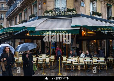 Les Deux Magots, the famous cafe and restaurant in Paris, France on a rainy day. March 24, 2023. Stock Photo