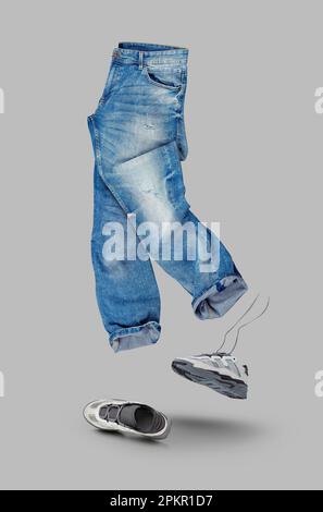 Blue jeans, white leather sneakers isolated on gray background. Branding clothes. Mock up for your design. With clipping path. Stock Photo