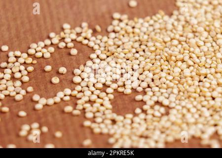 Organic quinoa seeds on brown paper background closeup Stock Photo