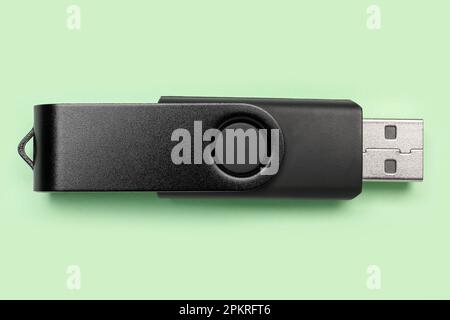 Black USB flash drive on green background Stock Photo