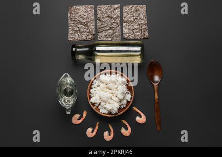 Composition with different ingredients for preparing tasty sushi rolls on dark background Stock Photo