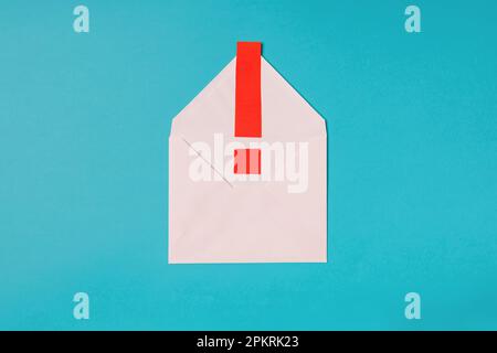 Email phishing concept, envelope and red exclamation mark on blue background Stock Photo