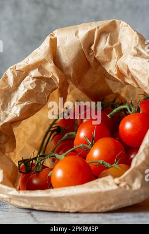 Cherry tomatoes in a brown paper bag. Eco friendly sustainable biodegradable plastic free packaging concept Stock Photo