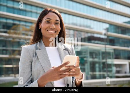 African American successful businesswoman with phone outside looking at camera. Stock Photo