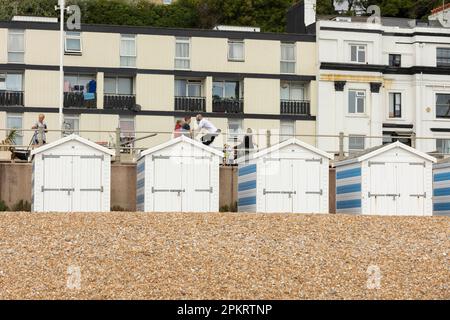 Hastings, united kingdom, 24, August 2022 Blue and white striped beach houses on a sunny beach in hastings Stock Photo
