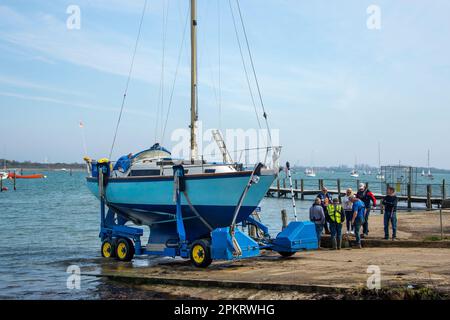 Yacht being launched on a slipway. Stock Photo