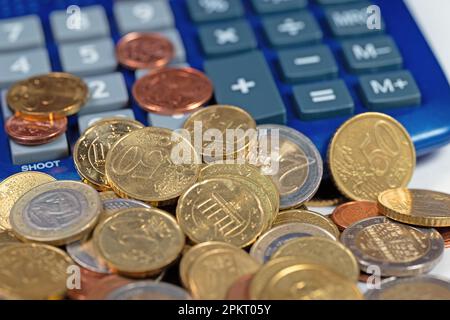 Euro coins and calculator in a close-up Stock Photo