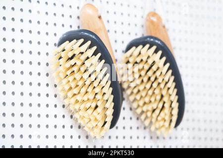 kitchen brushes hang in supermarket Stock Photo