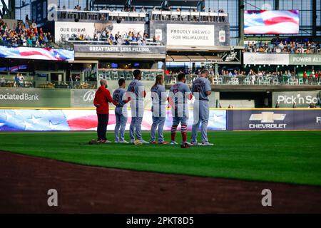 St. Louis Cardinals stand for the National Anthem, wearing pink