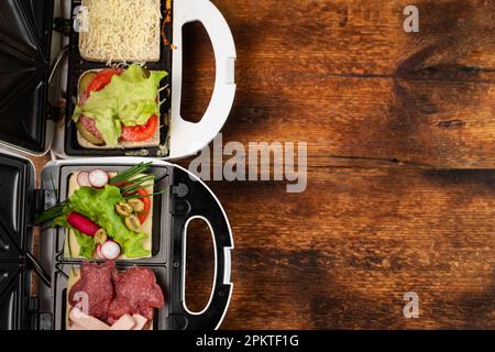 Vegetarian and meat-eating sandwich. Comparison. Sandwich stuffed with meat  sausages and ham against a stuffing of lettuce, onion, olives and tomato  Stock Photo - Alamy