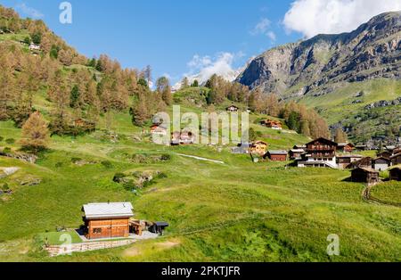 Summer panoramic view of beautiful mountainous scenery at Furi above Zermatt from the Matterhorn Express chairlift on a sunny day with blue sky Stock Photo