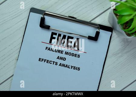 Concept of FMEA - Failure Modes and Effects Analysis write on paperwork isolated on Wooden Table. Stock Photo