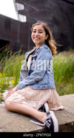 Female Asian Teen Seated Beside a Lily Pond | De Young Museum Stock Photo