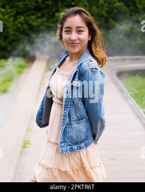 Asian Teen Walking on Misty Walkway | De Young Museum Gardens | Female | Short Dress Denim Jacket Stock Photo