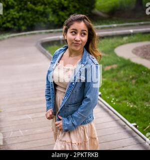 Asian Teen Walking on Misty Walkway | De Young Museum Gardens | Female | Short Dress Denim Jacket Stock Photo