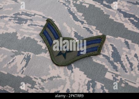 August 31, 2020. US AIR FORCE Airman First Class rank patch on digital tiger-stripe pattern Airman Battle Uniform (ABU) Stock Photo