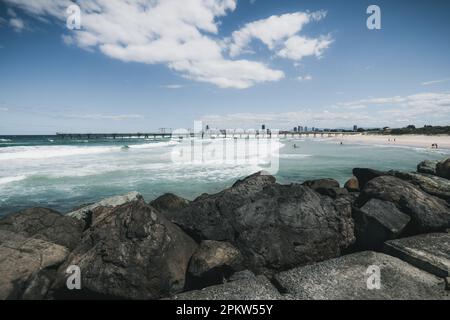 The Spit, Gold Coast, Queensland, Australia. View from the seaway, over the rocks towards the jetty. Stock Photo