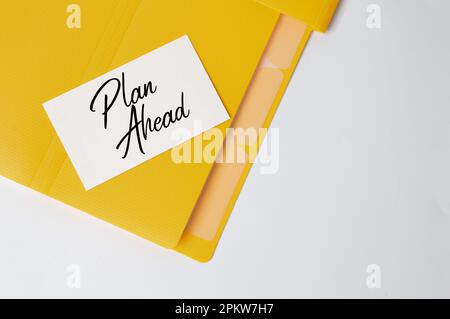 Memo note written with text PLAN AHEAD. Top view. Stock Photo
